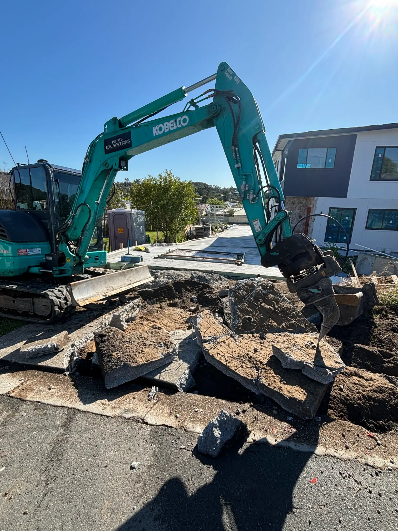 Plumb Excavations mini excavator clearing a residential block